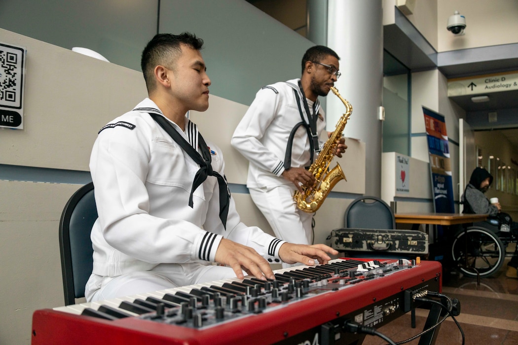 PORTLAND, OREGON (June 5, 2025) – U.S. Navy Musician 3rd class Dinos San Pedro, left, a native of California, and Musician 3rd class Jared Goodrum, a native of New Mexico, play music for veterans at the Portland VA Medical Center during Portland Fleet Week, June 5, 2025. Portland Fleet Week is a time-honored celebration of the sea services and provides an opportunity for the citizens of Oregon to meet Sailors, Marines, and Coast Guardsmen, as well as witness firsthand the latest capabilities of today’s maritime services. (U.S. Marine Corps photo by Sgt. Amelia Kang)