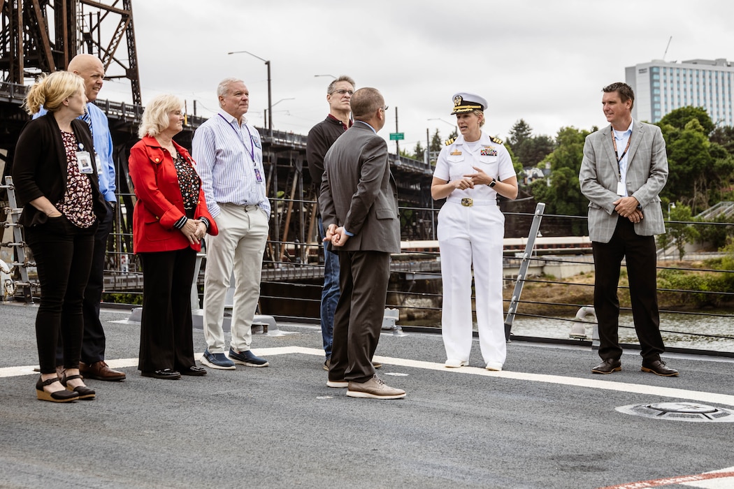 PORTLAND, OREGON (June 5, 2025) – U.S. Navy Cmdr. Christina Appleman, the commanding officer of the USS Mustin (DDG-89), and a California native, guides a ship tour for Portland education members during Portland Fleet Week, June 5, 2025. Portland Fleet Week is a time-honored celebration of the sea services and provides an opportunity for the citizens of Oregon to meet Sailors, Marines, and Coast Guardsmen, as well as witness firsthand the latest capabilities of today’s maritime services. (U.S. Marine Corps photo by Cpl. Peyton Kahle)