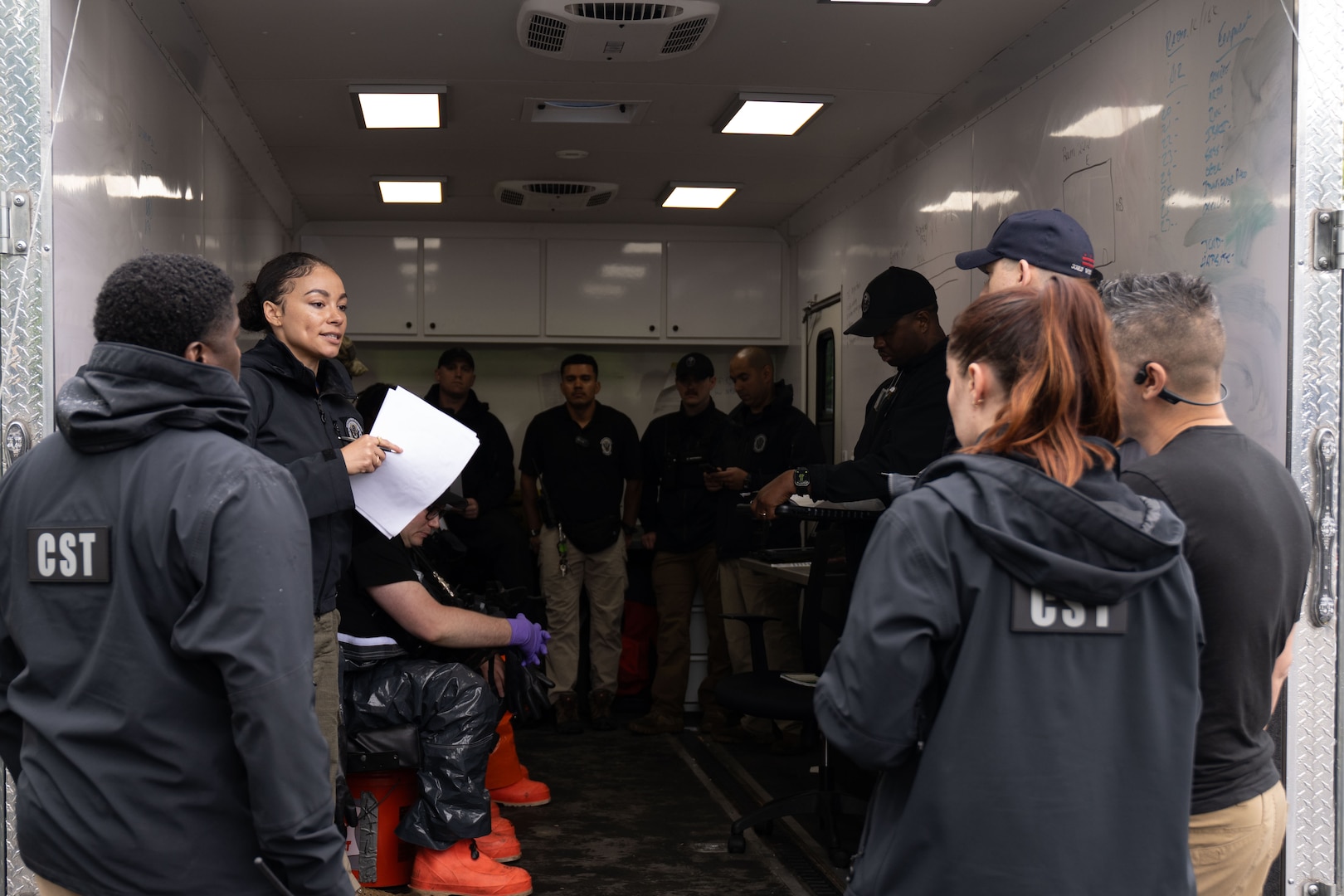 U.S. Army National Guard Staff Sgt. Maryann Marr, reconnaissance noncommissioned officer with the 33rd Weapons of Mass Destruction Civil Support Team, gives a pre-exercise brief for a full-scale chemical, biological, radiological, nuclear and explosive exercise at Joint Base Andrews, Md., May 21, 2025.  The exercise focused on identifying and mitigating an unknown CBRNE hazard.