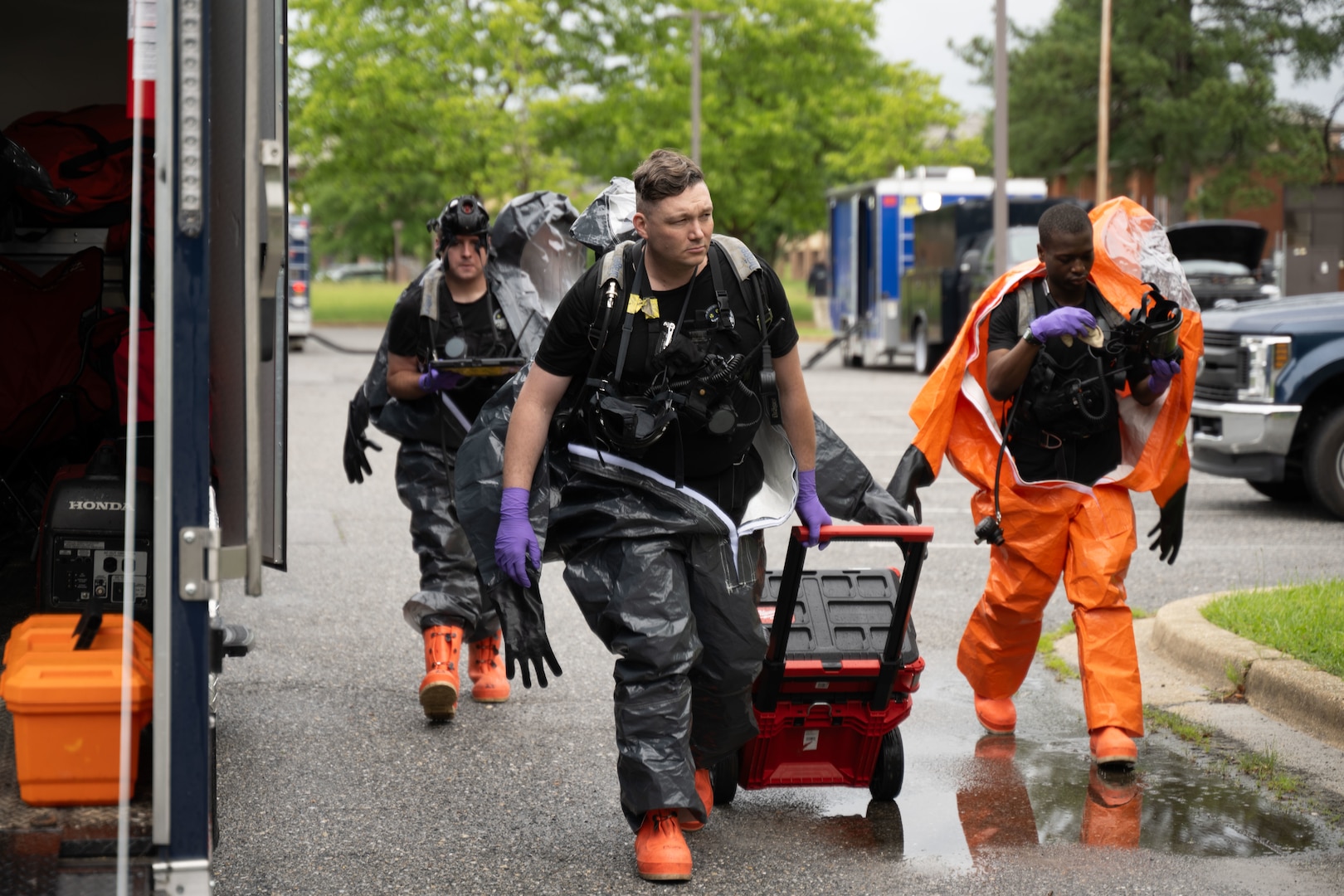 The 33rd Weapons of Mass Destruction Civil Support Team Survey Section approach the deconstruction line of a full-scale chemical, biological, radiological, nuclear and explosive exercise at Joint Base Andrews, Md., May 21, 2025. Conducting the exercise at Andrews provided the team with a realistic and dynamic training environment.