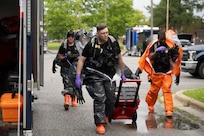 The 33rd Weapons of Mass Destruction Civil Support Team Survey Section approach the deconstruction line of a full-scale chemical, biological, radiological, nuclear and explosive exercise at Joint Base Andrews, Md., May 21, 2025. Conducting the exercise at Andrews provided the team with a realistic and dynamic training environment.