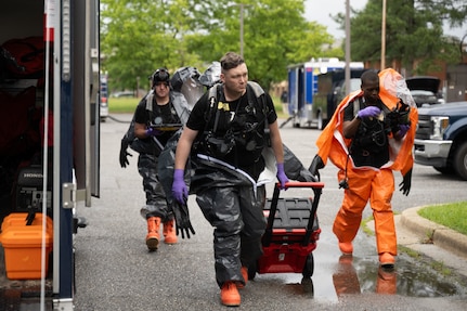 The 33rd Weapons of Mass Destruction Civil Support Team Survey Section approach the deconstruction line of a full-scale chemical, biological, radiological, nuclear and explosive exercise at Joint Base Andrews, Md., May 21, 2025. Conducting the exercise at Andrews provided the team with a realistic and dynamic training environment.