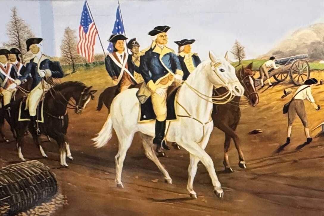 A battle painting of American soldiers in the foreground wearing various uniforms carrying muskets, drums and flags, standing and sitting on a ridge of a hill. British soldiers in uniform stand in formation on a plain below.