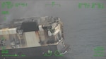 A Coast Guard C-130J Super Hercules aircrew from Coast Guard Air Station Kodiak conducts an overflight of a fire aboard the cargo vessel Morning Midas approximately 260 miles southwest of Adak, June 8, 2025. The Coast Guard is in close communication with Zodiac Maritime, the manager of the Morning Midas, as they develop their salvage and safety plans with Resolve Marine. (U.S. Coast Guard photo courtesy of Air Station Kodiak)