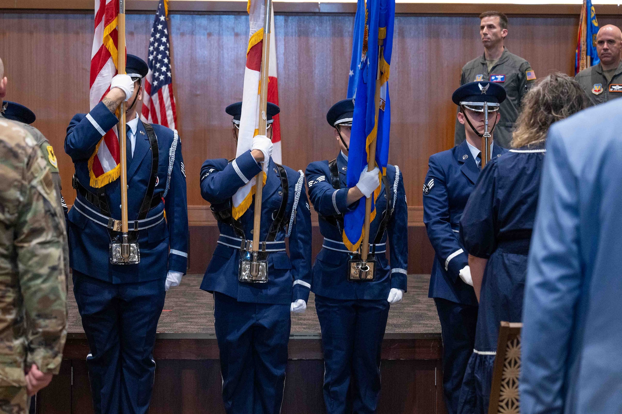 U.S. Service members hold the flags for a change of command ceremony.