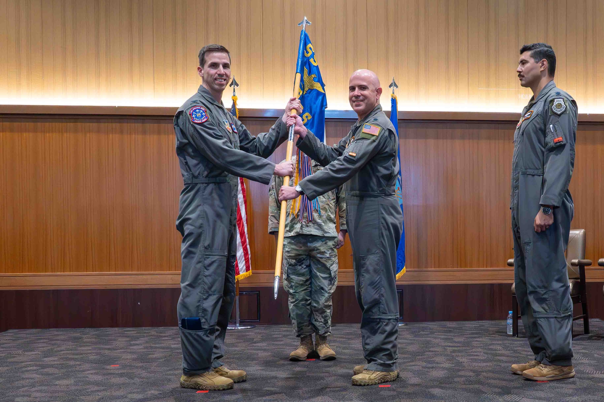 Two service members holding the guidon.