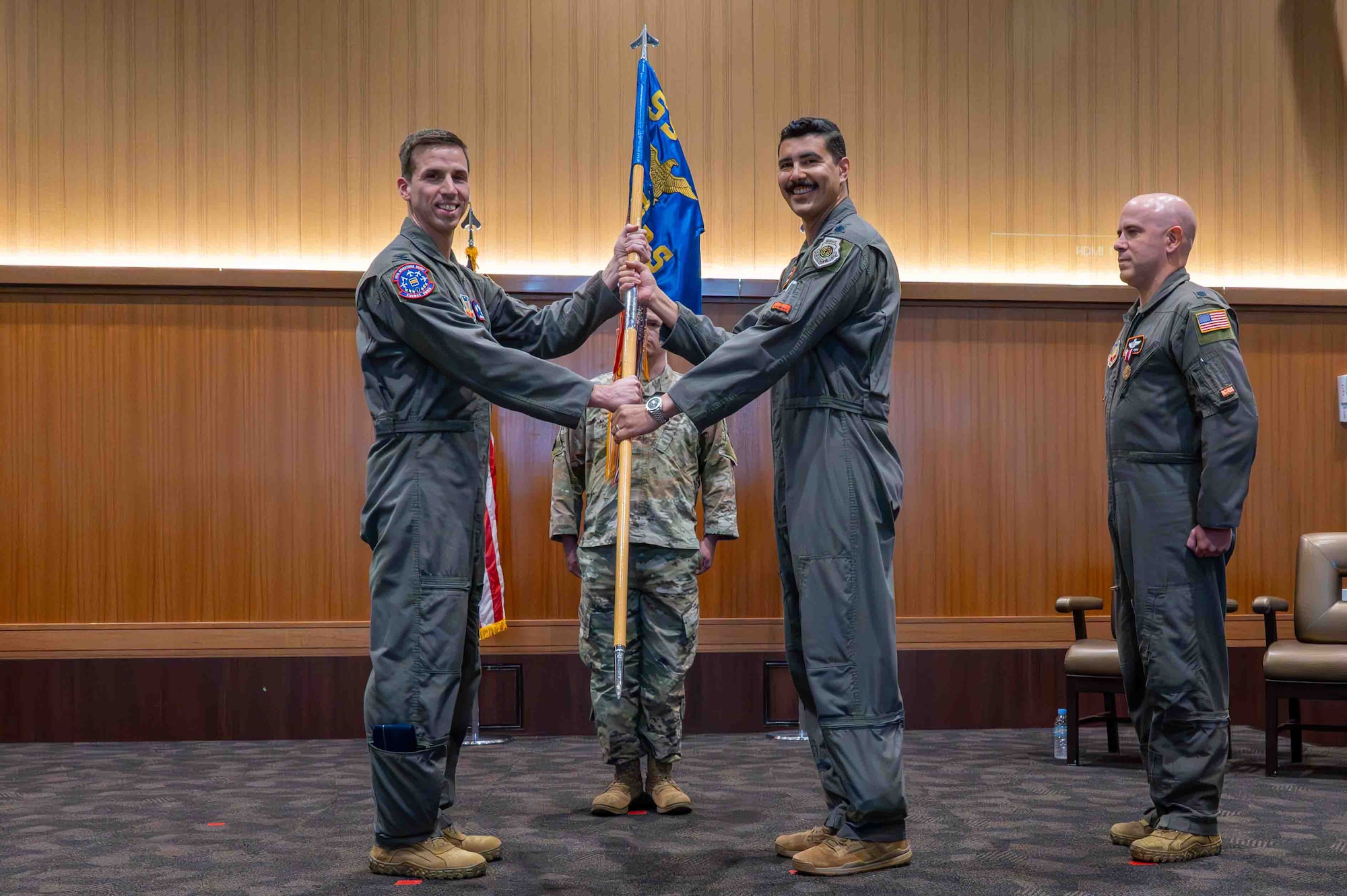 Two service members holding the guidon.