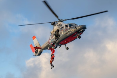 FRENCH POLYNESIA (May 31, 2025) — A Marine Nationale rescue swimmer descends from a French Navy Flottille 35F AS365 Dauphin helicopter during a joint training exercise between the French Navy and U.S. Coast Guard Cutter Harriet Lane (WMEC 903) on...