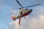 A Marine Nationale rescue swimmer descends from a French Navy Flottille 35F AS365 Dauphin helicopter during a joint training exercise between the French Navy and U.S. Coast Guard Cutter Harriet Lane (WMEC 903) on May 31, 2025 off the Coast of Tahiti, French Polynesia.