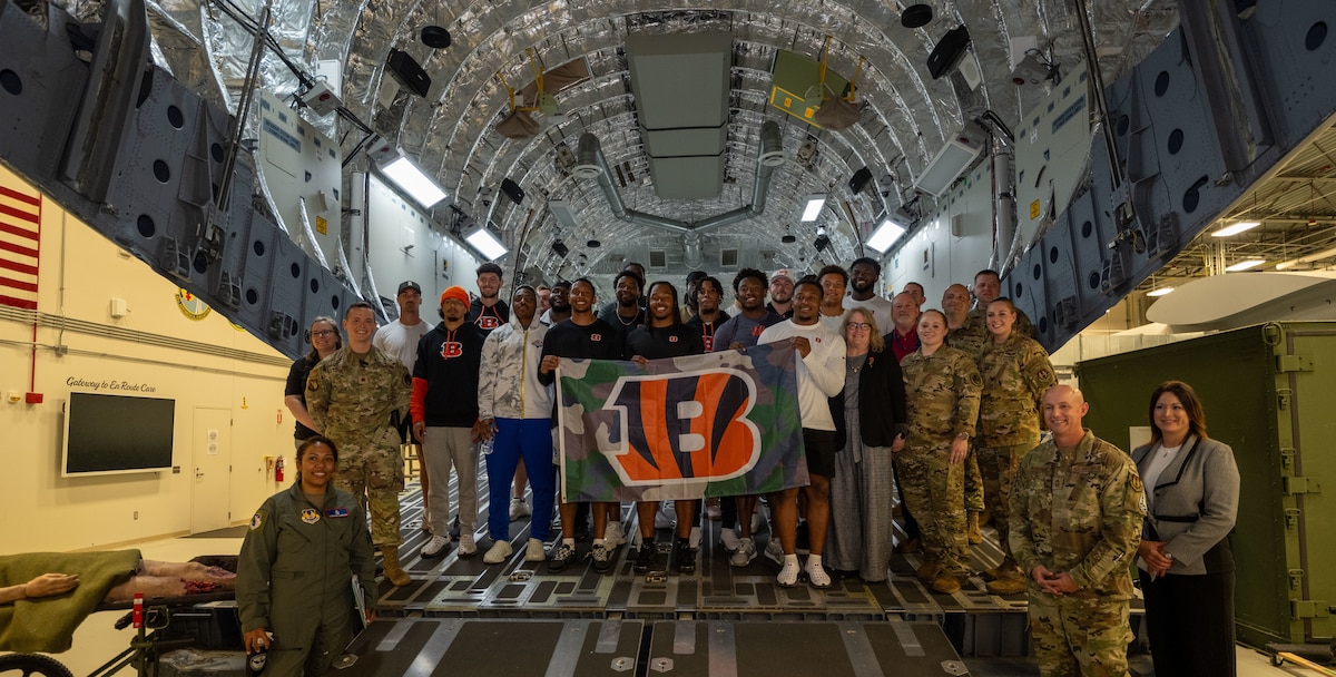 Cincinnati Bengals rookies and military members from Wright-Patterson Air Force Base pose for a group photo inside the C-130 training simulator