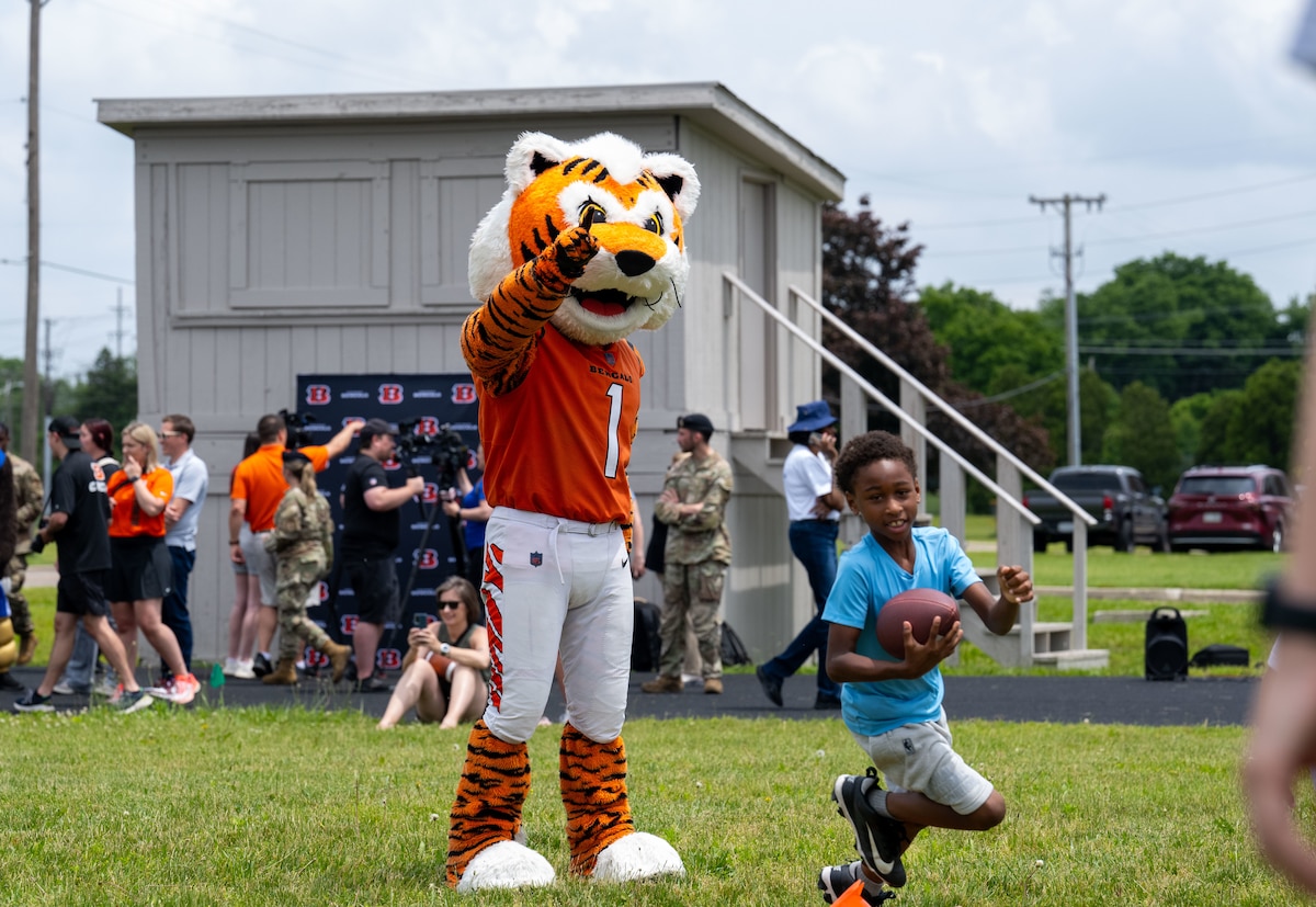Who Dey, the Cincinnati Bengals mascot, participates in a skills and drills clinic with military children.