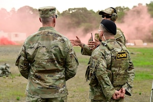 Military personnel have a conversation.