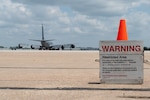 A restricted area signs marks the entrance to where Airmen assigned to the 155th Air Refueling Wing, are conducting pre-flight inspections on a KC-135 Stratotanker, at the Nebraska National Guard air base in Lincoln, Nebraska, June 6, 2025. The Airmen were participating in a three-day Combat Readiness Exercise which evaluates the wing's ability to rapidly mobilize, deploy and sustain operations in a simulated contingency environment. (U.S. Air National Guard photo by Staff Sgt. Noah Carlson)