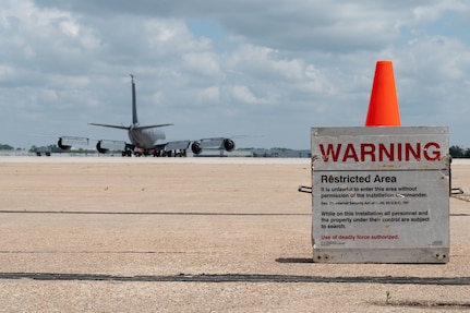 A restricted area signs marks the entrance to where Airmen assigned to the 155th Air Refueling Wing, are conducting pre-flight inspections on a KC-135 Stratotanker, at the Nebraska National Guard air base in Lincoln, Nebraska, June 6, 2025.