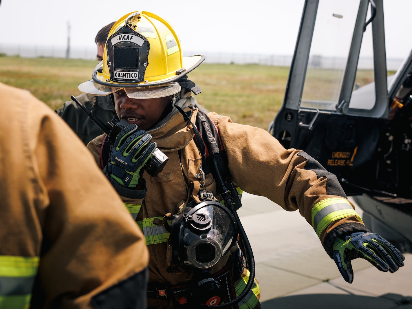 U.S. Marine Corps Sgt. Nathaniel Vinson, an expeditionary firefighting and rescue specialist with Marine Corps Air Facility Quantico, speaks on a radio during a helicopter medical evacuation exercise at MCAF Quantico on Marine Corps Base Quantico, Virginia, June 4, 2025. Marines conducts training consisting of loading and unloading ordnance and helicopter medical evacuations to increase mission readiness in the event of an emergency. (U.S. Marine Corps photo by Lance Cpl. Braydon Rogers)