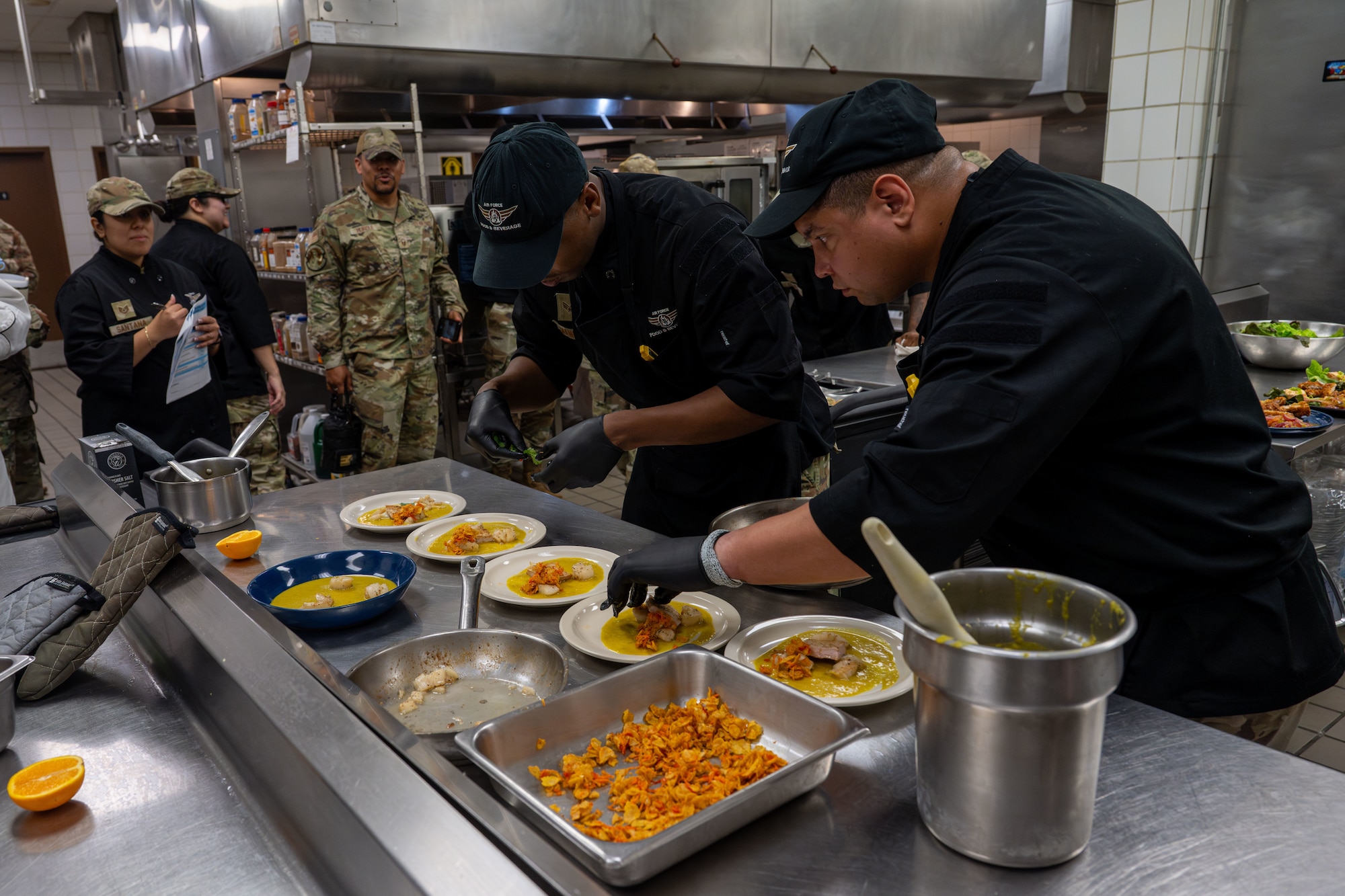 Airmen participate in the Chisholm Trail Inn Dining Facility SHEF (Salute Hospitality Epicurean Faceoff) competition at McConnell Air Force Base, Kansas, June 4, 2025. The participating team from Altus AFB, Missouri, won the competition with a curried scallop and pork dish. (U.S. Air Force photo by Airman 1st Class Paula Arce)