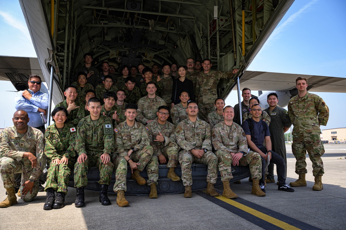 U.S. Air Force Language Enabled Airman Program scholars pose for a photo with Japan Ground Self-Defence Force soldiers after a briefing from Airmen from the 374th Maintenance Squadron during a three-week integration at Yokota Air Base, Japan, May 15, 2025. During their time at Yokota, the LEAP scholars visited multiple units including the 374th Logistics Readiness Squadron and 374 MXS to observe day-to-day operations and identify real-world scenarios where cultural and linguistic understanding can shape outcomes. (U.S. Air Force photo by Staff Sgt. Manuel G. Zamora)