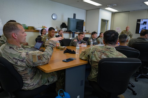 Languaged Enabled Airman Program participants engage in discussion during the Agile Combat Employment brief at Yokota Air Base, Japan, May 15th 2025. As the Air Force continues to build regional partnerships, LEAP ensures Airmen are mission-ready, culturally aware and capable of leading in diverse operational environments. (U.S. Air Force photo by Staff Sgt. Manuel G. Zamora)