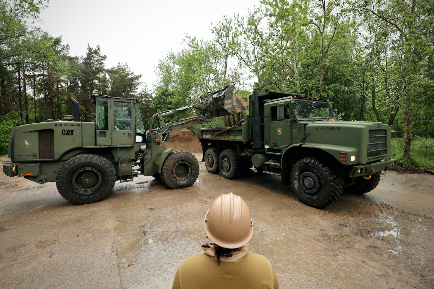 U.S. Marines with 8th Engineer Support Battalion, Combat Logistics Regiment 27, 2nd Marine Logistics Group, U.S. Navy Sailors assigned to Naval Construction Battalion (NCB) 14 and Latvian service members with Kurzemes 4th Brigade Engineering Unit clear debris in preparation for a portable boat ramp installation during exercise Baltic Operations 2025 (BALTOPS 25), June 9, 2025, in Liepaja, Latvia.