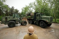 U.S. Marines with 8th Engineer Support Battalion, Combat Logistics Regiment 27, 2nd Marine Logistics Group, U.S. Navy Sailors assigned to Naval Construction Battalion (NCB) 14 and Latvian service members with Kurzemes 4th Brigade Engineering Unit clear debris in preparation for a portable boat ramp installation during exercise Baltic Operations 2025 (BALTOPS 25), June 9, 2025, in Liepaja, Latvia.