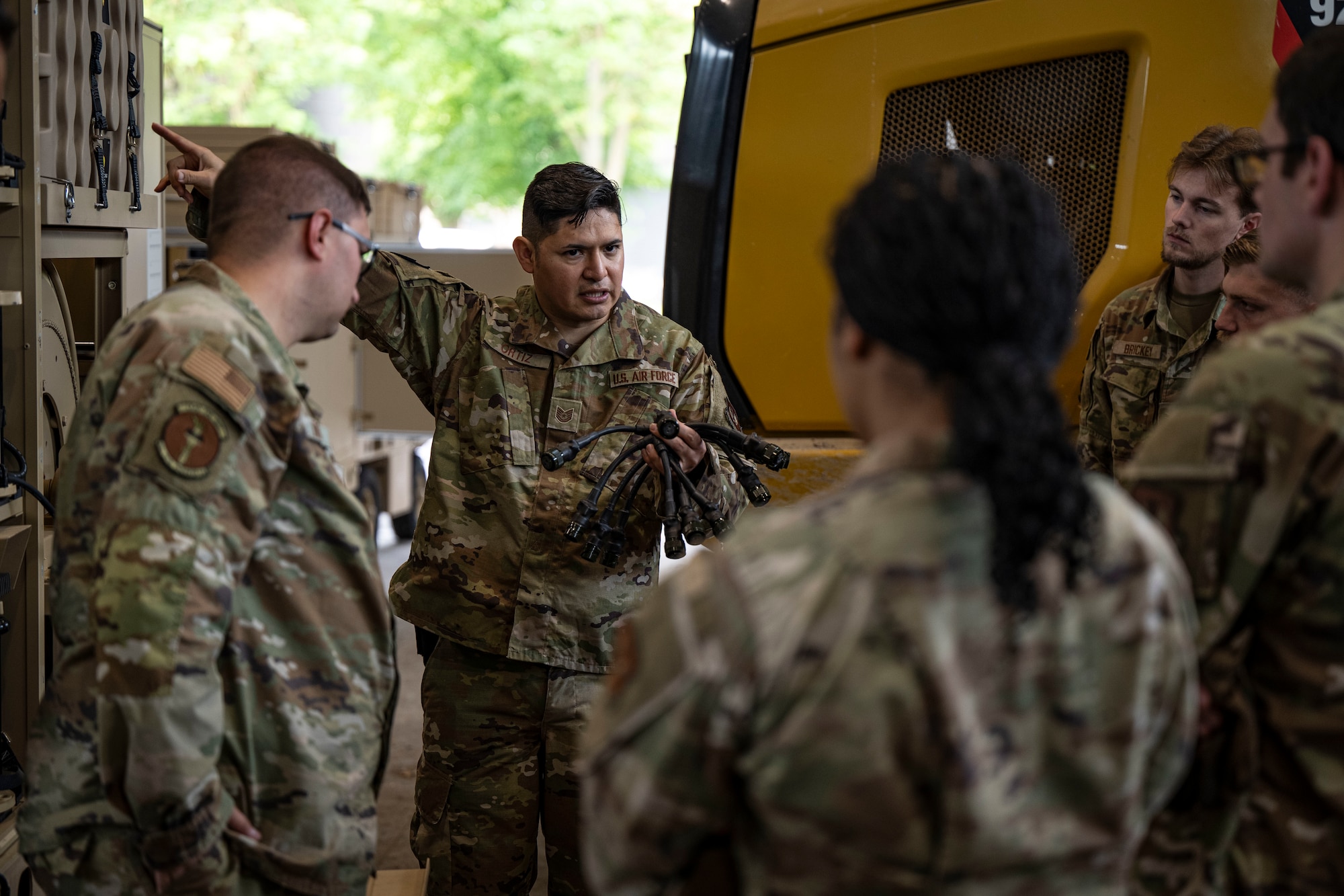 U.S. Air Force Tech. Sgt. Martin Figueroa Ortiz, 48th Civil Engineer Squadron electrical systems section chief, instructs Airmen assigned to the 100th Civil Engineer Squadron on airfield lighting cable connections at RAF Feltwell, England, June 6, 2025.