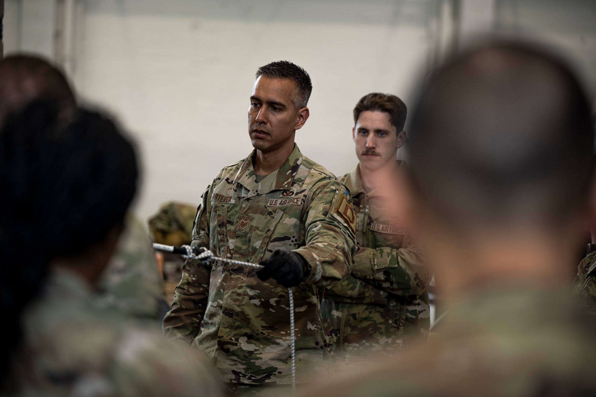 U.S. Air Force Master Sgt. Julio Arteaga, 100th Civil Engineer Squadron electrical systems section chief, demonstrates cable deployment from an expeditionary airfield lighting system at RAF Feltwell, England, June 6, 2025.