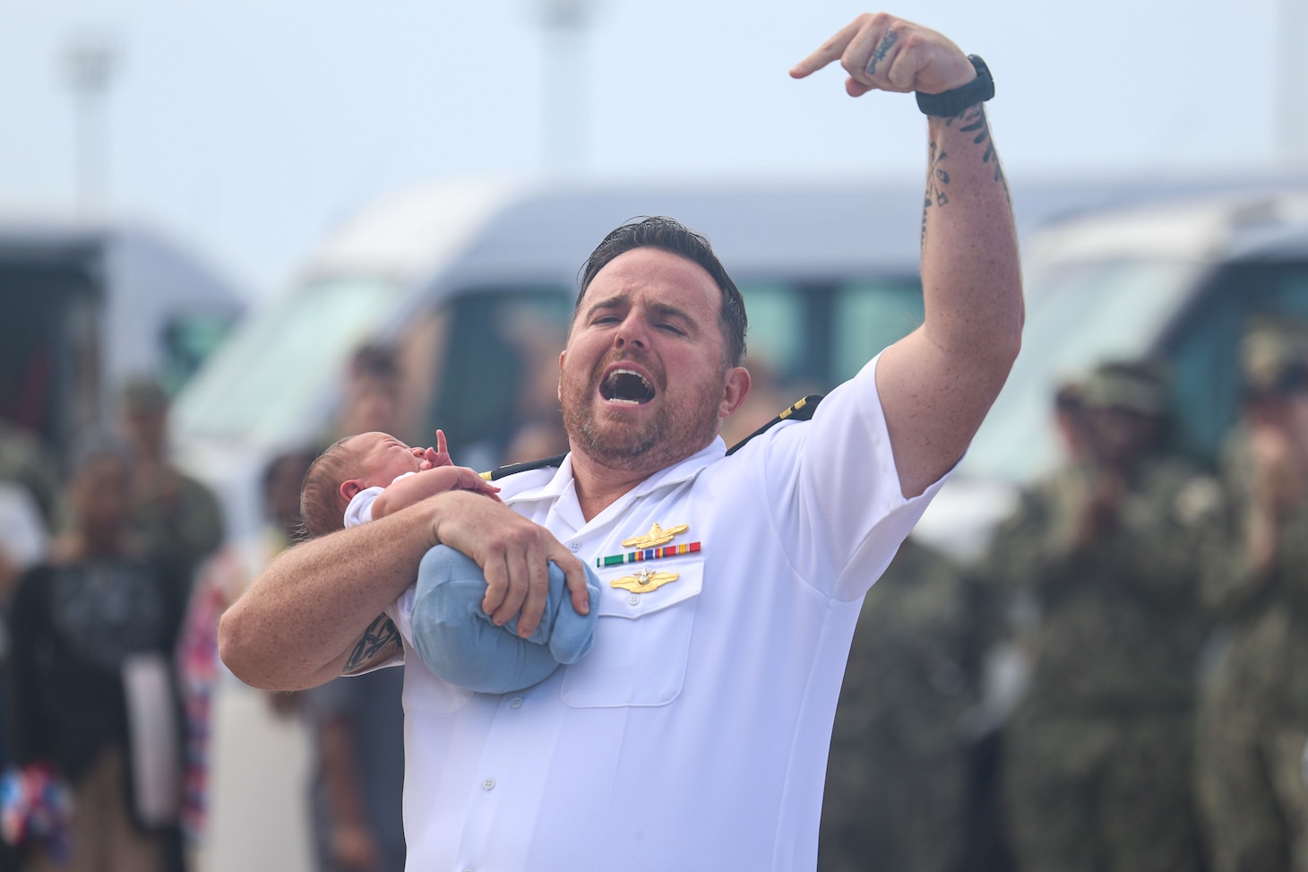 Lt. Kevin Kyle, assigned to the Arleigh Burke-class guided-missile destroyer USS Oscar Austin (DDG 79), holds his newborn during the ship’s return to Naval Station Rota, Spain, June 10, 2025. Oscar Austin completed its first patrol in the U.S. Naval Forces Europe area of operations, employed by U.S. 6th Fleet to defend U.S., Allied, and partner interests in the region.