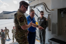 A 91st Missile Maintenance Airman briefs Tom Rafferty, Military Affairs Committee chairman, on the payload transporter vehicle during a Military Affairs Committee luncheon at Minot Air Force Base, North Dakota, June 5, 2025. These vital vehicles are responsible for transporting the Minuteman III intercontinental ballistic missile across vast distances, utilizing public roads to reach strategic locations, and ensuring precise emplacement or removal at launch facilities. (U.S. Air Force photo by Senior Airman Alex Nottingham)