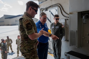 A 91st Missile Maintenance Airman briefs Tom Rafferty, Military Affairs Committee chairman, on the payload transporter vehicle during a Military Affairs Committee luncheon at Minot Air Force Base, North Dakota, June 5, 2025. These vital vehicles are responsible for transporting the Minuteman III intercontinental ballistic missile across vast distances, utilizing public roads to reach strategic locations, and ensuring precise emplacement or removal at launch facilities. (U.S. Air Force photo by Senior Airman Alex Nottingham)
