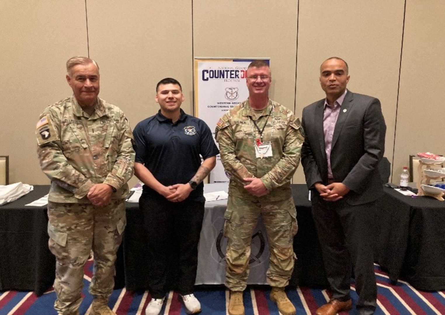 Chief Warrant Officer Four Bill Elliott, Tribal Liaison with the Washington Military Department, Sgt. Isaiah Salgado, Sgt. 1st Class Scott Salmon, Washington National Guard Counterdrug Program members pose for a photo with Washington Attorney General Nick Brown at Tribal Opioid/Fentanyl Summit, May 22, 2025 at the Cowlitz Tribe’s reservation in Ridgefield, Wash.