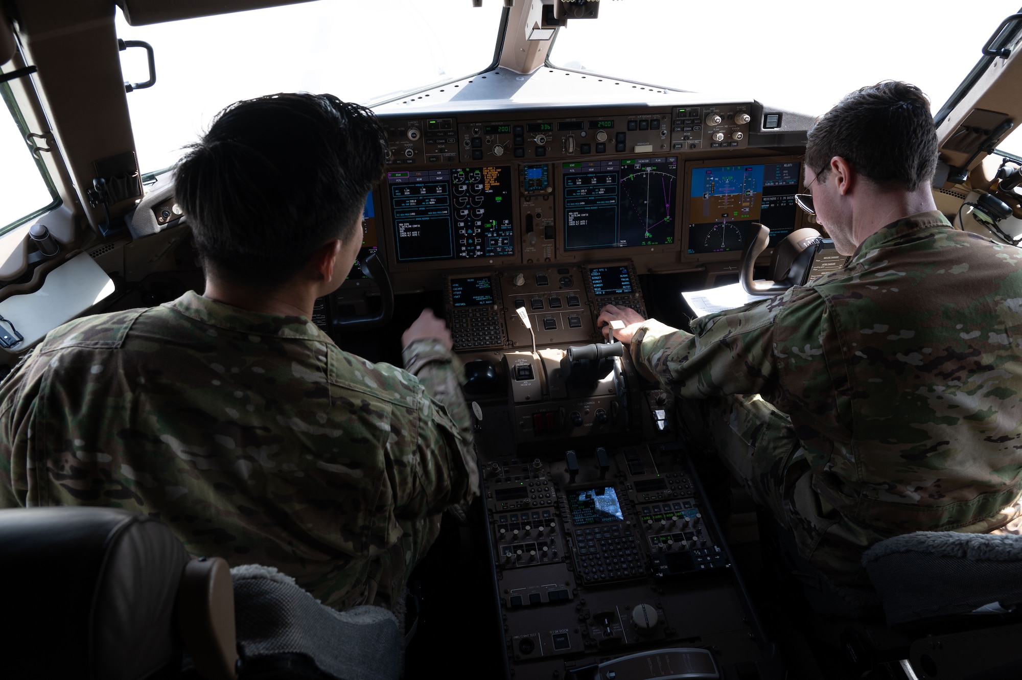 U.S. Air Force Maj. Andrew Kim, left, and Capt. Christian Perricone, 32nd Expeditionary Air Refueling Squadron pilots, perform preflight checks in the U.S. Central Command area of responsibility, June 5, 2025. The KC-46A Pegasus provides aerial refueling, cargo transport and aeromedical evacuation capabilities, and has supported air refueling operations since 2019. (U.S. Air Force photo by Senior Airman Dieondiere Jefferies)