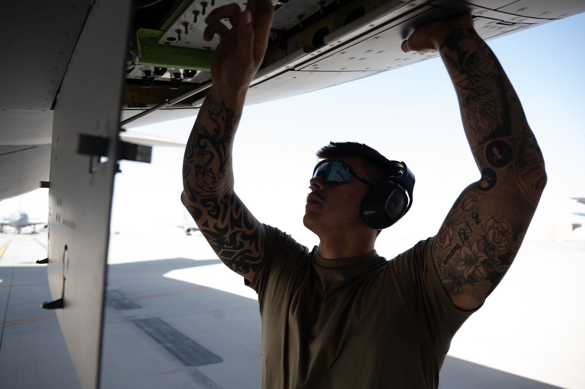 Airman 1st Class Roman Moore, 32nd Expeditionary Air Refueling Squadron crew chief, performs preflight checks on a KC-46A Pegasus within the U.S. Central Command area of responsibility, June 5, 2025. The KC-46A is  equipped with defensive and communication features making it more survivable in a contested environment. (U.S. Air Force photo by Senior Airman Dieondiere Jefferies)