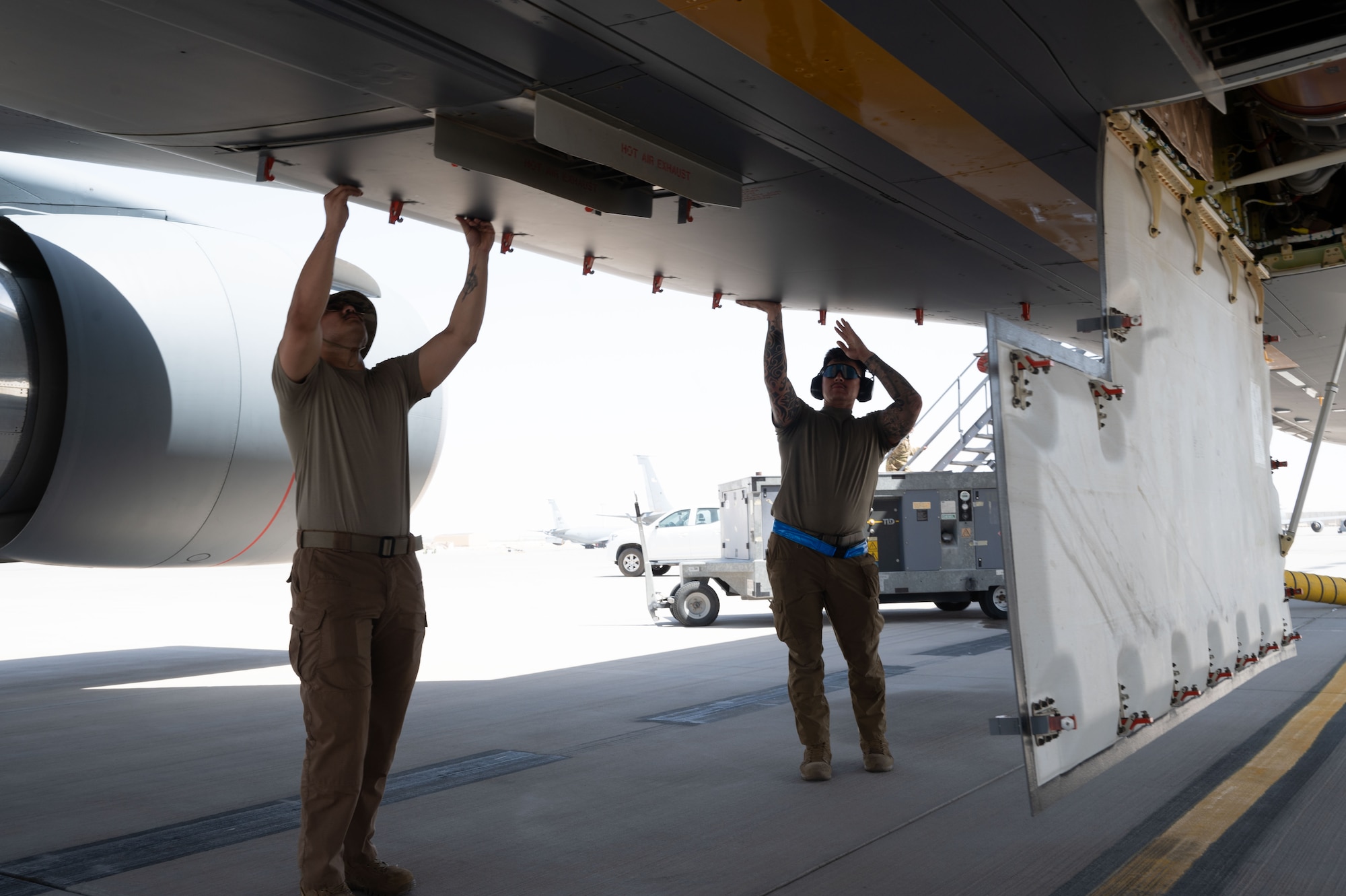 Airman 1st Class Wilberto Ojeda, left, 32nd Expeditionary Air Refueling Squadron avionics journeyman, and Airman 1st Class Roman Moore, right, 32nd EARS crew chief, manipulate KC-46A Pegasus panels in preparation for launch within the U.S. Central Command area of responsibility, June 5, 2025. The KC-46A has refueling, cargo and aeromedical evacuation capabilities and has played a pivotal role in air refueling since 2019. (U.S. Air Force photo by Senior Airman Dieondiere Jefferies)