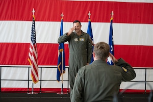 Col. Charles Huber, 10th Air Force Deputy Director of Operations and Plans, renders the customary first salute to Brig. Gen. Kevin Merrill during the 10th Air Force change of command ceremony at Naval Air Station Joint Reserve Base Fort Worth, Texas, June 8, 2025.
