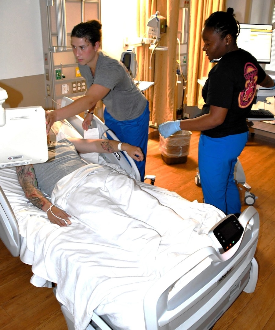 Lt. Memphis Martin (L), a registered nurse and PFC Lore Vil, an LPN check vitals on a patient at Womack Army Medical Center on April 23, 2025.