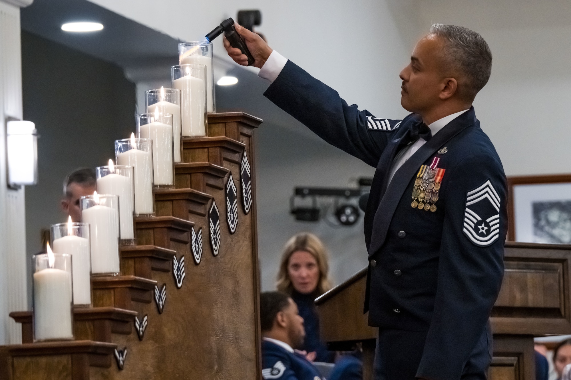 Chief Master Sgt. Alejandro Gonzalez, lights the chiefs candle.