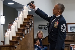 Chief Master Sgt. Alejandro Gonzalez, lights the chiefs candle.