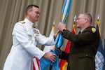 Personnel taking part in a relinquishment ceremony.