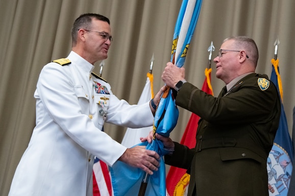Personnel taking part in a relinquishment ceremony.