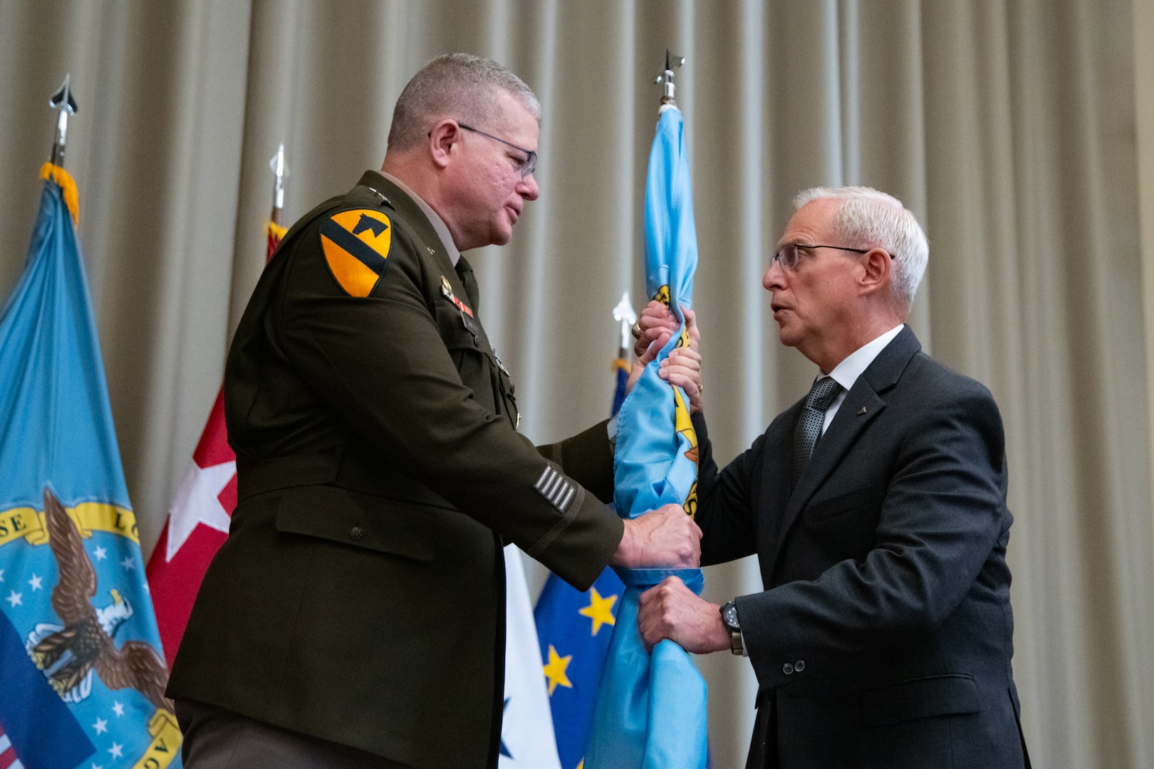 Personnel taking part in a relinquishment ceremony.