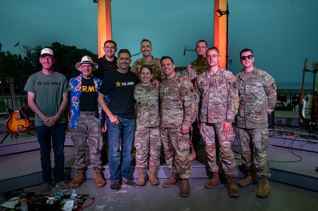 Past and present members of the U.S. Army Training Doctrine and Command Band pose for a photo.