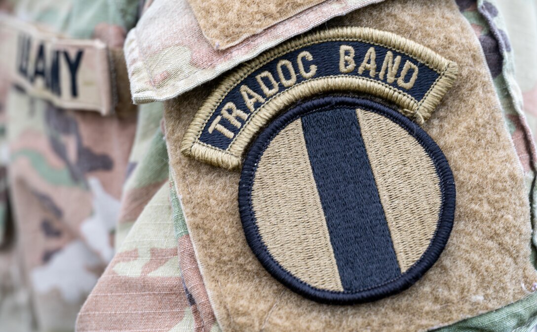 A U.S. Army Soldier assigned to the Training Doctrine and Command Band showcases his patch.