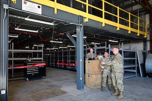 Col. Reginald Trujillo, 944th Mission Support Group commander
 and Col. Peter Abercrombie, 56th MSG commander, cut the ribbon on the new Explosive Ordnance Disposal mezzanine, at Luke Air Force Base, Ariz., June 3, 2025. The previous infrastructure was unsafe for equipment storage and Airmen movements. (U.S. Air Force Photo by MSgt Courtney Richardson)