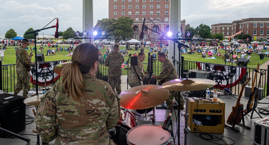 The U.S. Army Training Doctrine and Command Rock Band performs.