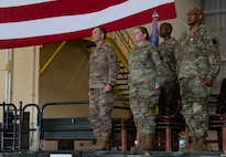 U.S. Air Force Col. Jesse Lamarand, 5th Bomb Wing commander, Col. Rofelio Grinston, 5th Maintenance Group (5MXG) commander, and Col. Tiffany Arnold, incoming 5MXG commander, stand at attention during the 5MXG change of command ceremony at Minot Air Force Base, North Dakota, June 4, 2025. During the ceremony, Grinston relinquished command to Col. Jesse Lamarand. (U.S. Air Force photo by Senior Airman Alex Nottingham)