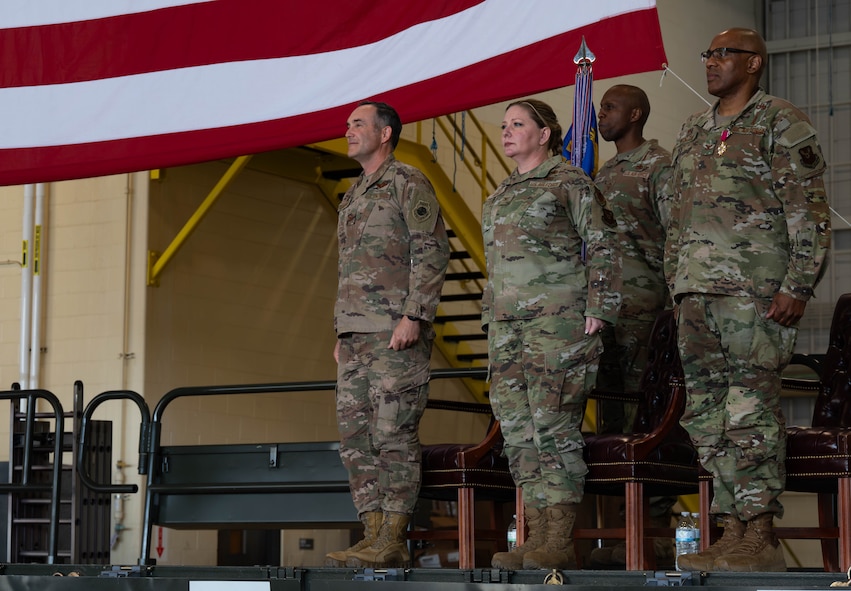 U.S. Air Force Col. Jesse Lamarand, 5th Bomb Wing commander, Col. Rofelio Grinston, 5th Maintenance Group (5MXG) commander, and Col. Tiffany Arnold, incoming 5MXG commander, stand at attention during the 5MXG change of command ceremony at Minot Air Force Base, North Dakota, June 4, 2025. During the ceremony, Grinston relinquished command to Col. Jesse Lamarand. (U.S. Air Force photo by Senior Airman Alex Nottingham)