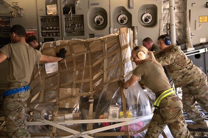 Airmen assigned to the 73rd Aerial Port Squadron, TSgt Edward Alvarado and AMN Danielle Cook, push a cargo load for transport aboard a C-17 Globemaster III at Travis Air Force Base, Calif., April 14, 2025. The hands-on training familiarizes Airmen with real-world loading procedures and enhances readiness for future deployment operations.