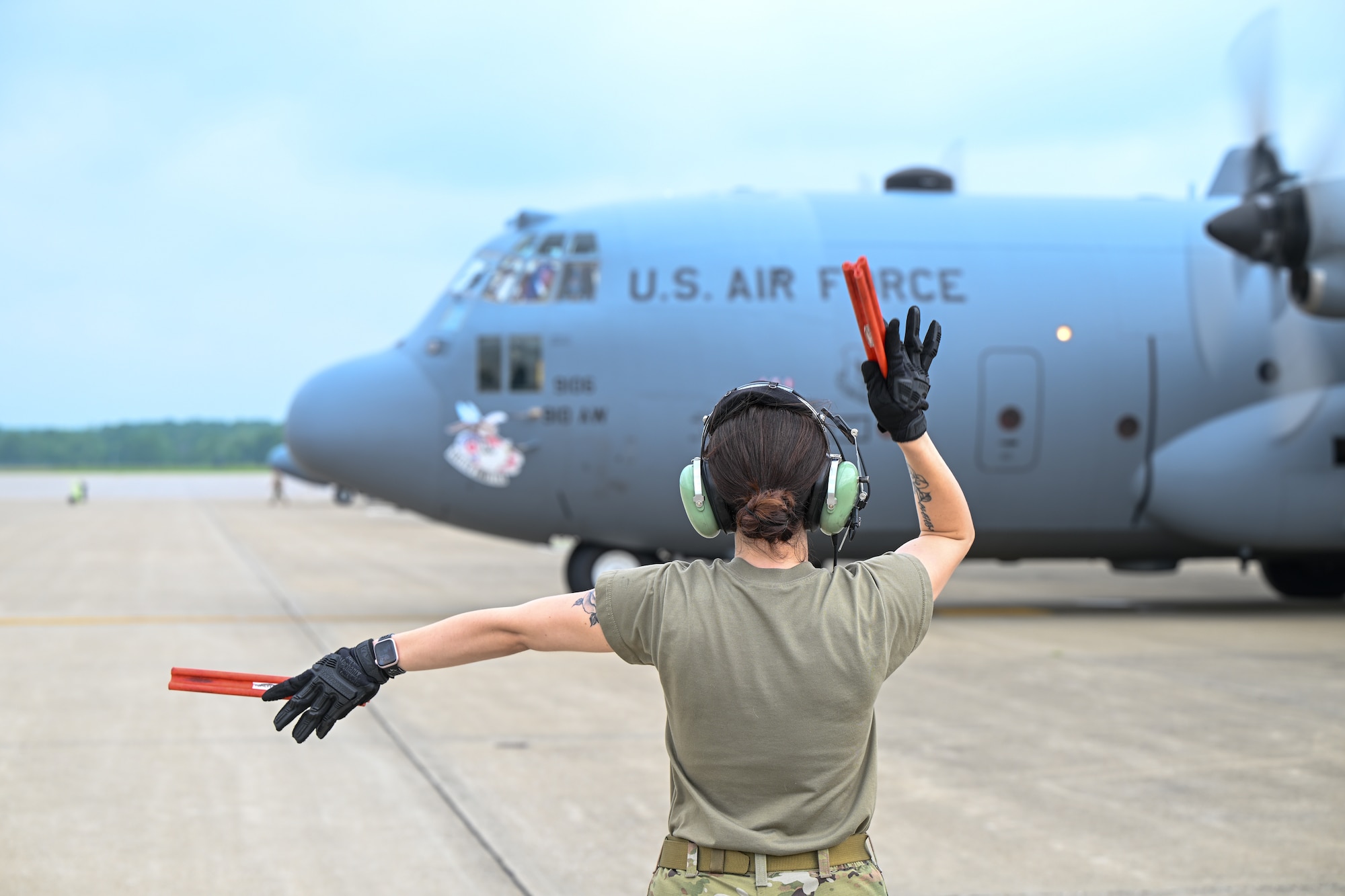 Staff Sgt. Sydney Lewis, a maintainer assigned to the 910th Aircraft Maintenance Squadron, marshals aircraft 9106 for its final flight from Youngstown Air Reserve Station, Ohio, as a 910th Airlift Wing aircraft, June 9, 2025.
