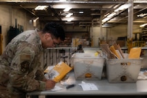 Airman Joseph Romero, Traffic Management Office inbound cargo technician, confirms a delivery at Minot Air Force Base, North Dakota, Jun 3, 2025. Every box is opened and inspected to count the quantity of cargo inside. (U.S. Air Force Senior Airmen Alex Nottingham)