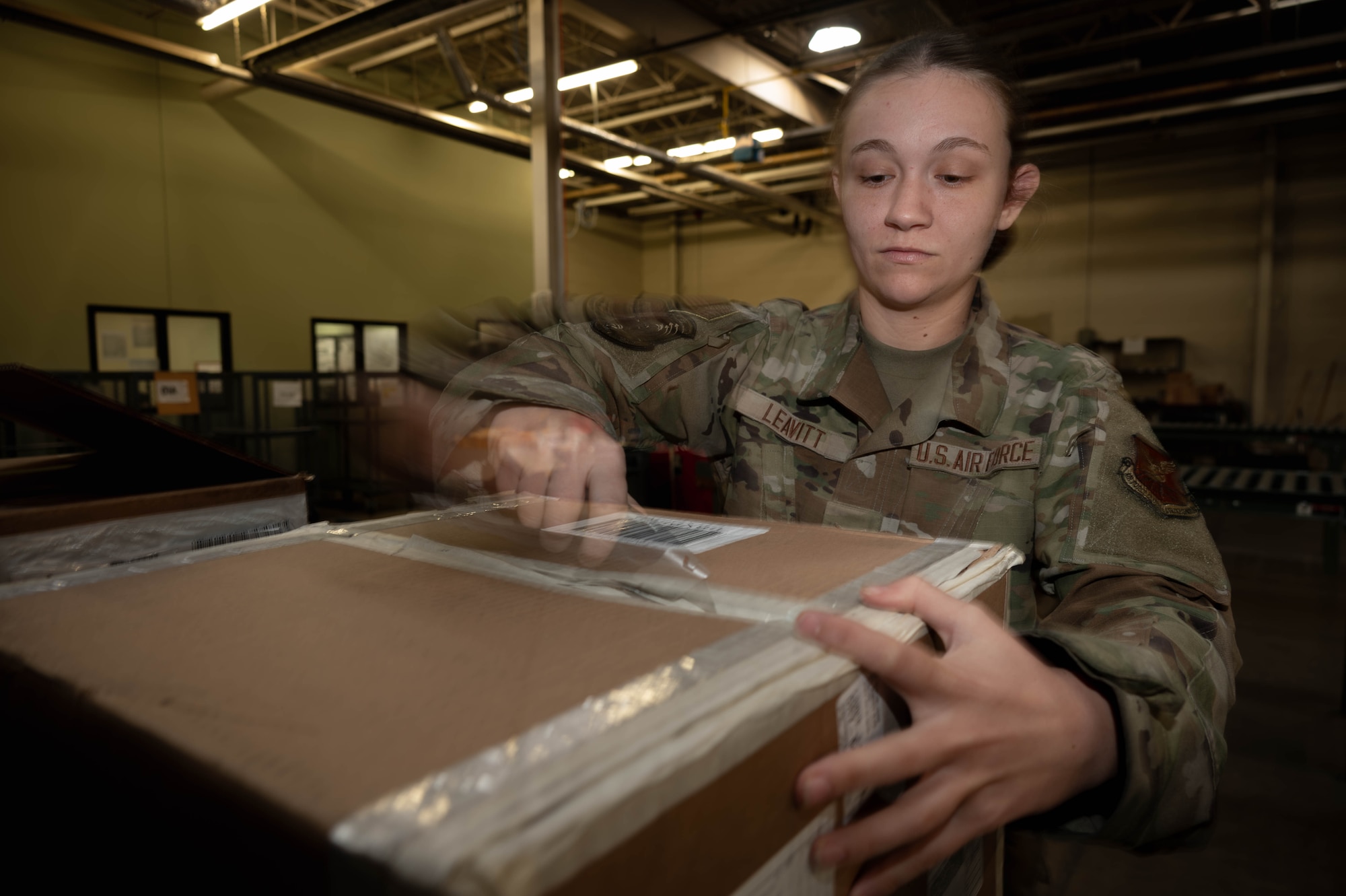 Airman 1st Class Emily Leavitt, Traffic Management Office inbound cargo technician, opens a piece of cargo at Minot Air Force Base, North Dakota, Jun 3, 2025. Every box is opened and inspected to count the quantity of cargo inside. (U.S. Air Force Senior Airmen Alex Nottingham)